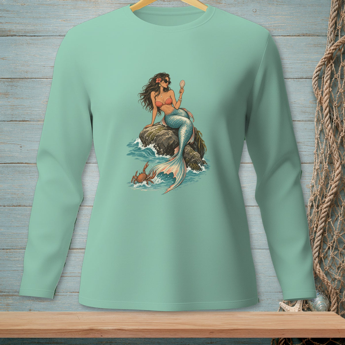 Mermaid with shell sitting on rock with crab in waves.