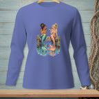 Two mermaids with colorful tails sit on a wooden pier talking.