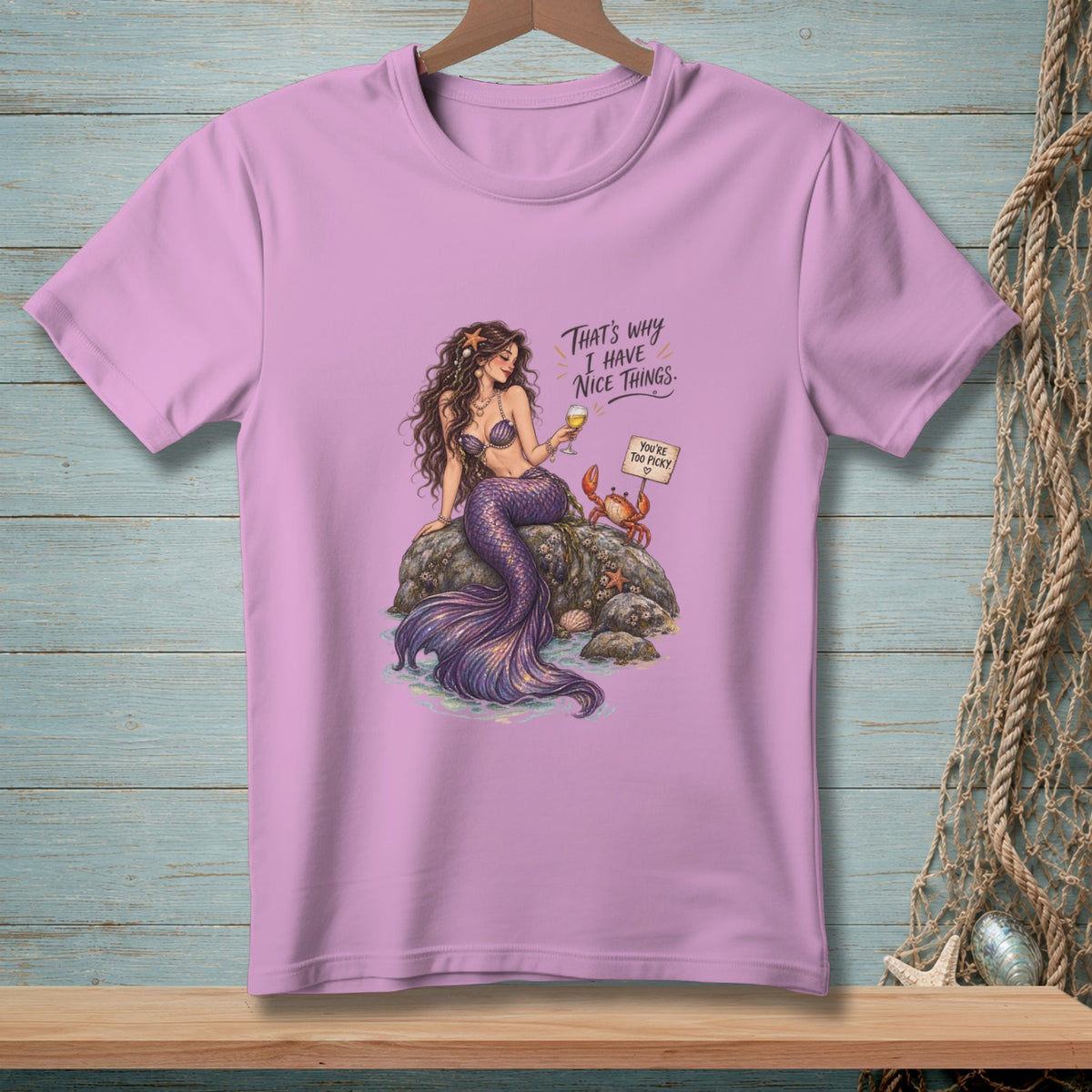 Mermaid on a rock with a drink, a crab, and text.
