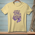 Yellow t-shirt with "I have a tail and an attitude" mermaid graphic.