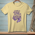 Yellow t-shirt with "I have a tail and an attitude" mermaid graphic.