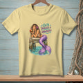 Yellow t-shirt with mermaid graphic and text "Salty, Tangled & Unbothered."
