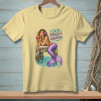 Yellow t-shirt with mermaid graphic and text "Salty, Tangled & Unbothered."
