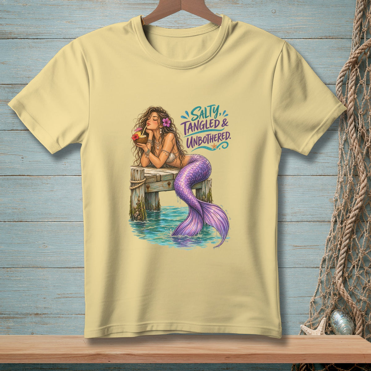 Yellow t-shirt with mermaid graphic and text "Salty, Tangled & Unbothered."