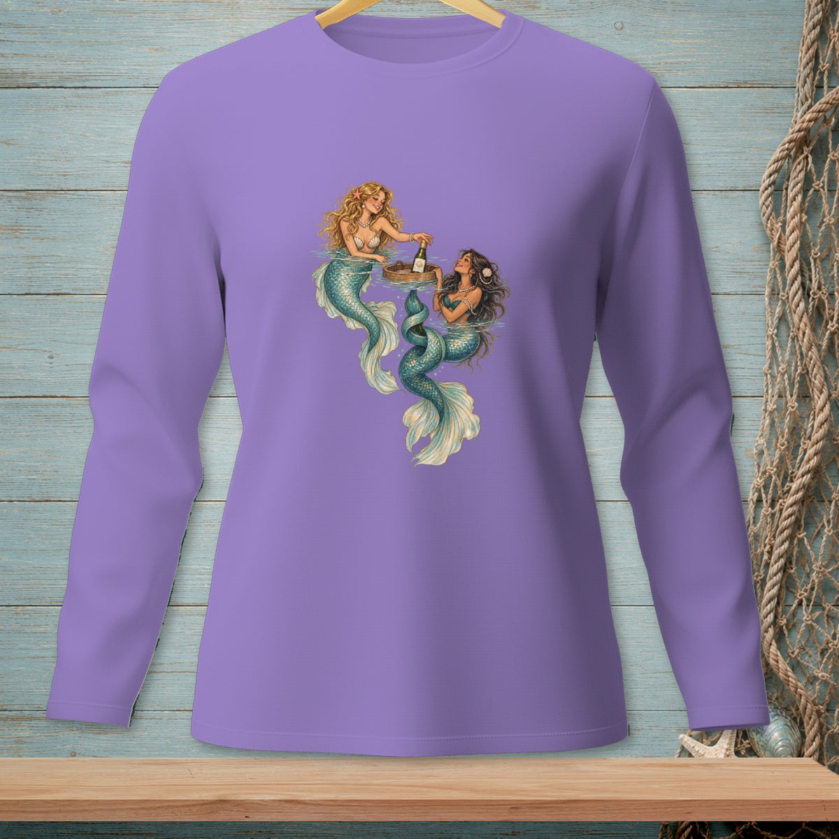 Two mermaids with green tails and brown hair share a drink from a tray.