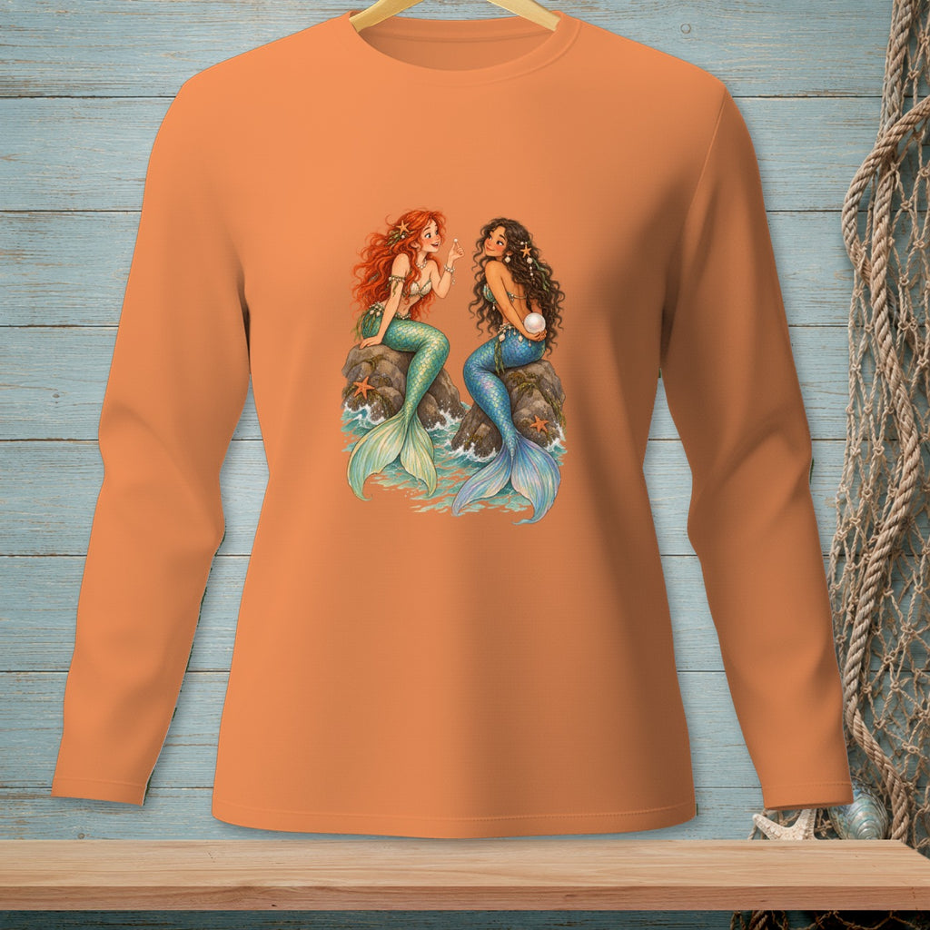 Two mermaids, one with red hair, one with dark hair, sitting on rocks.