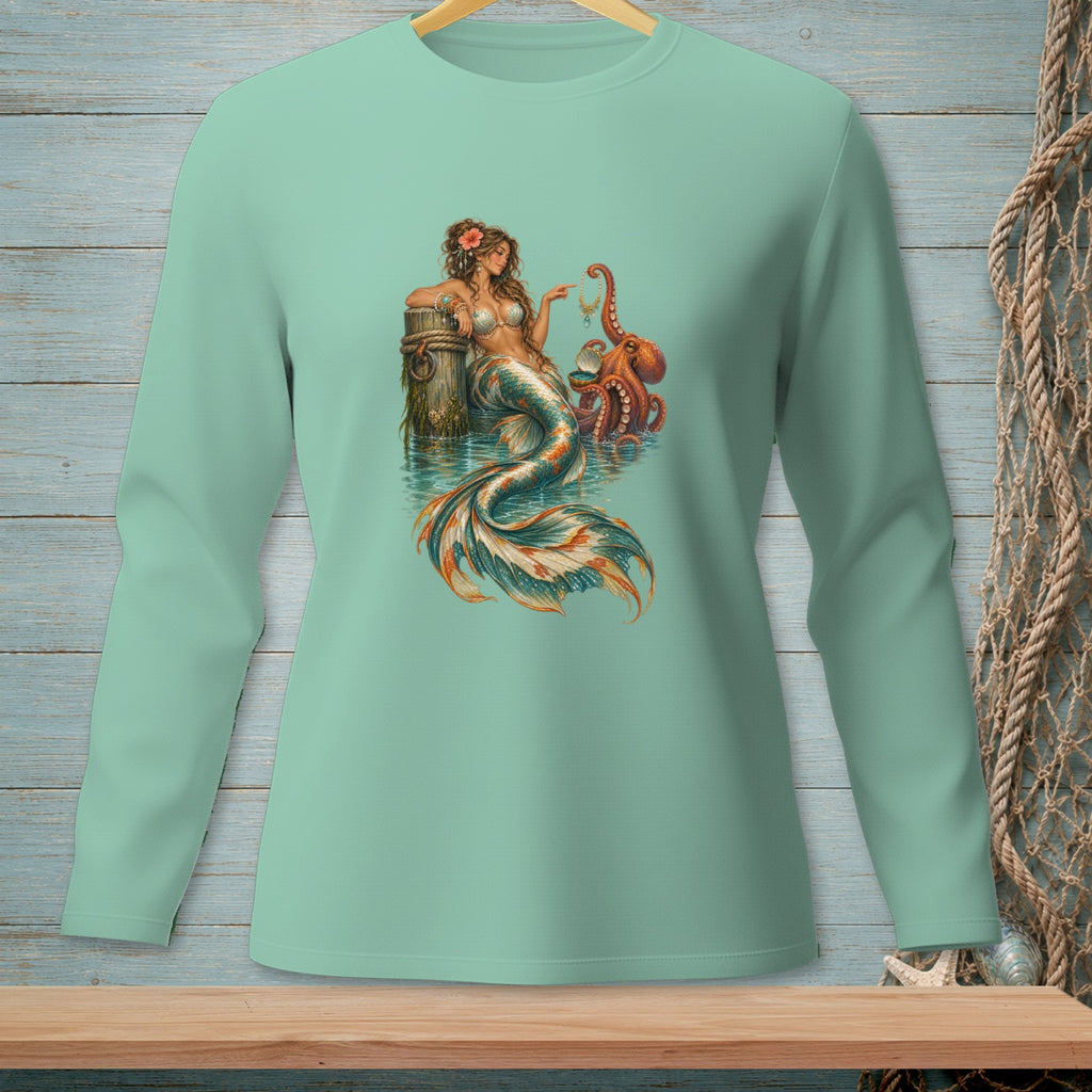 Mermaid with octopus by wooden post and pearls on mint long sleeve shirt.
