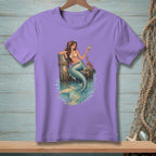 Mermaid with drink and crab sitting on a dock post.