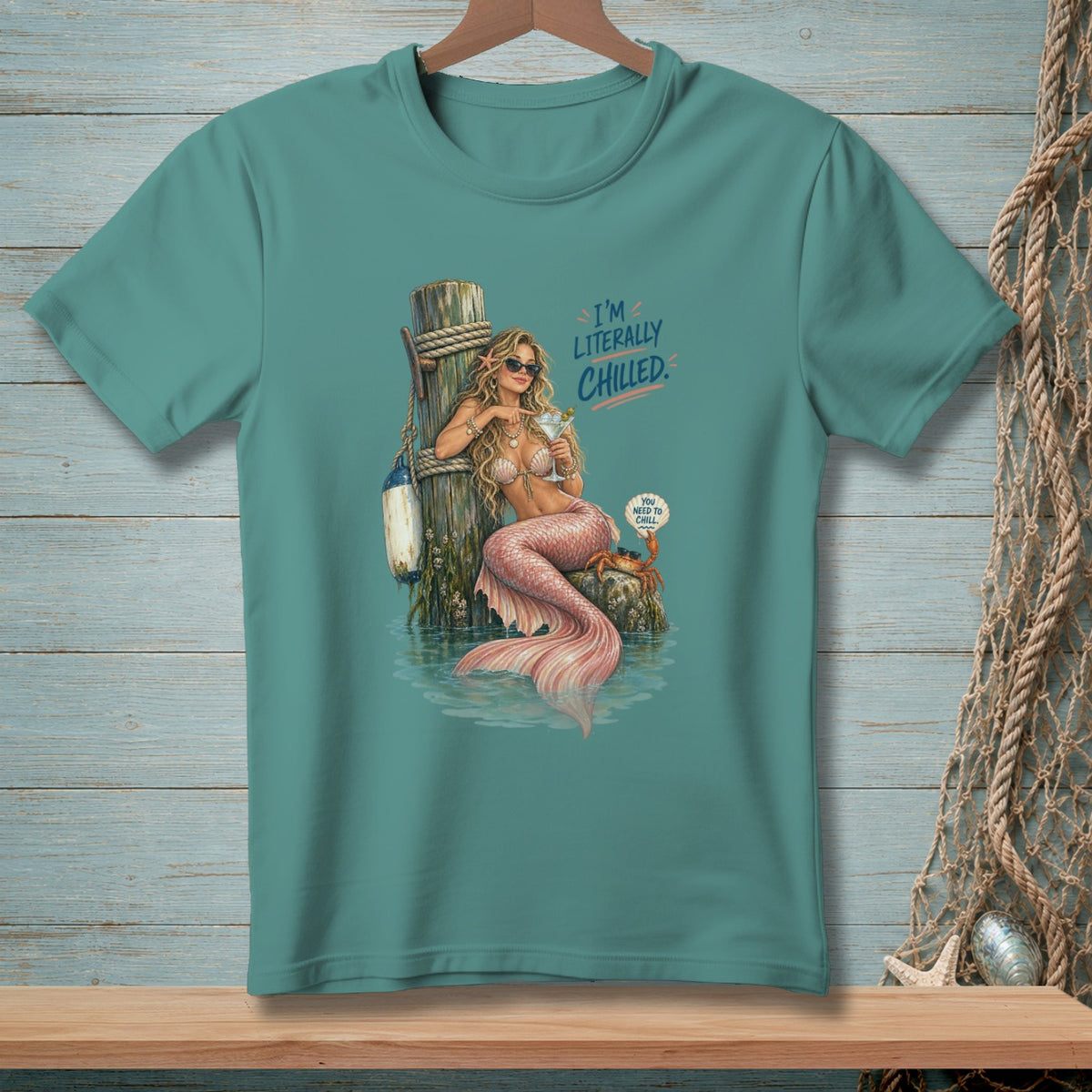 Mermaid with martini on dock, text "I'm Literally Chilled", crab with speech bubble.