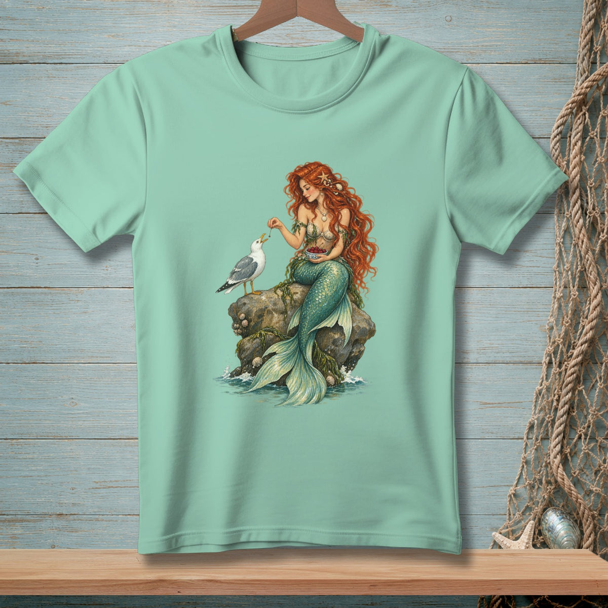 Mermaid sitting on rock feeding a seagull berries.