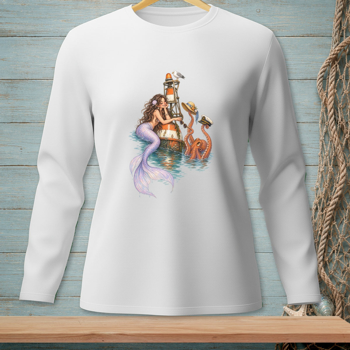 Long-sleeve white t-shirt with mermaid, octopus, lighthouse, and seagull graphic.