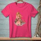 Pink t-shirt with a mermaid sitting on a rock with shells and a crab.