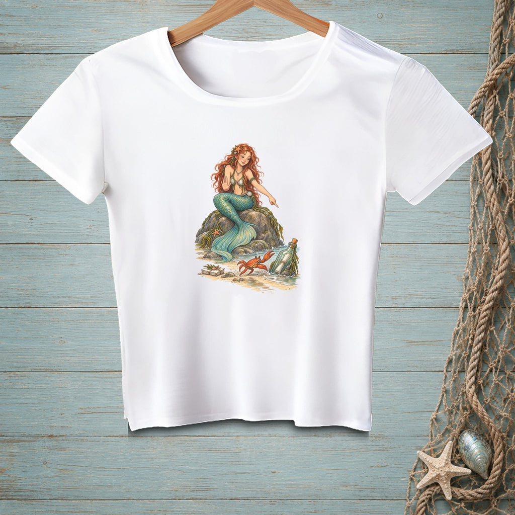 White t-shirt with illustration of a mermaid, crab, and bottle on a rock.