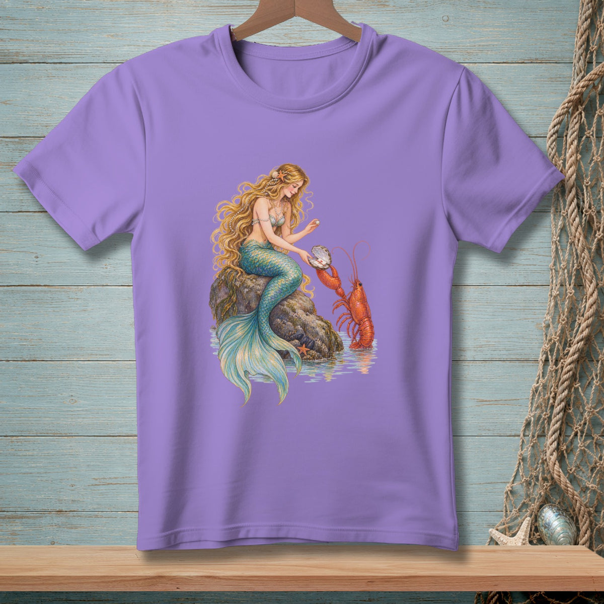 Purple t-shirt with a print of a mermaid interacting with a lobster and a shell.