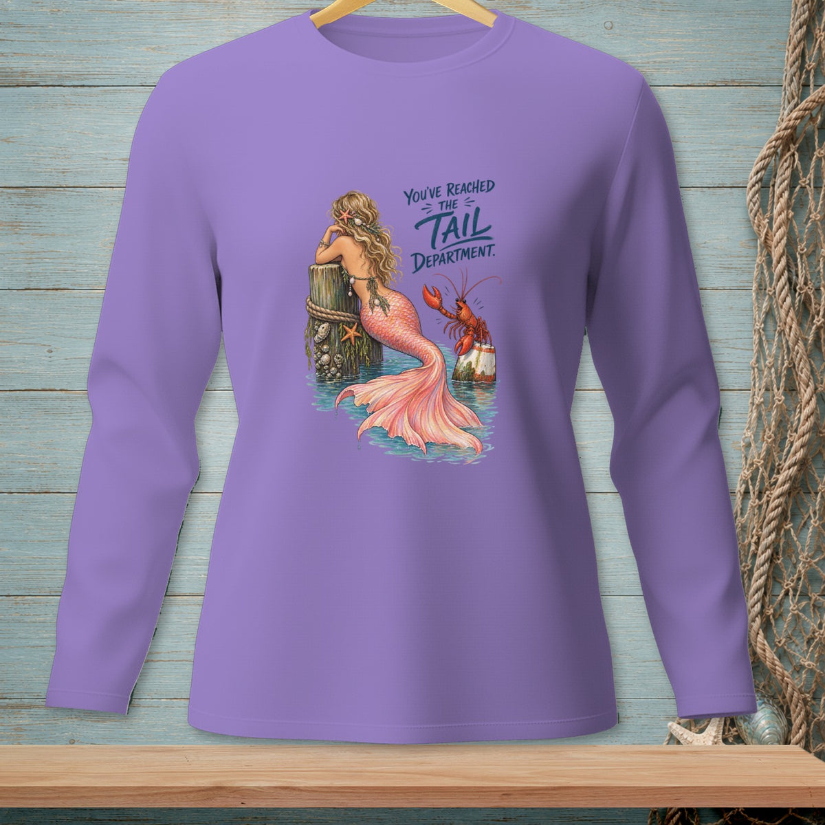 Purple long-sleeve shirt with a mermaid and lobster graphic reading "You've reached the tail department."