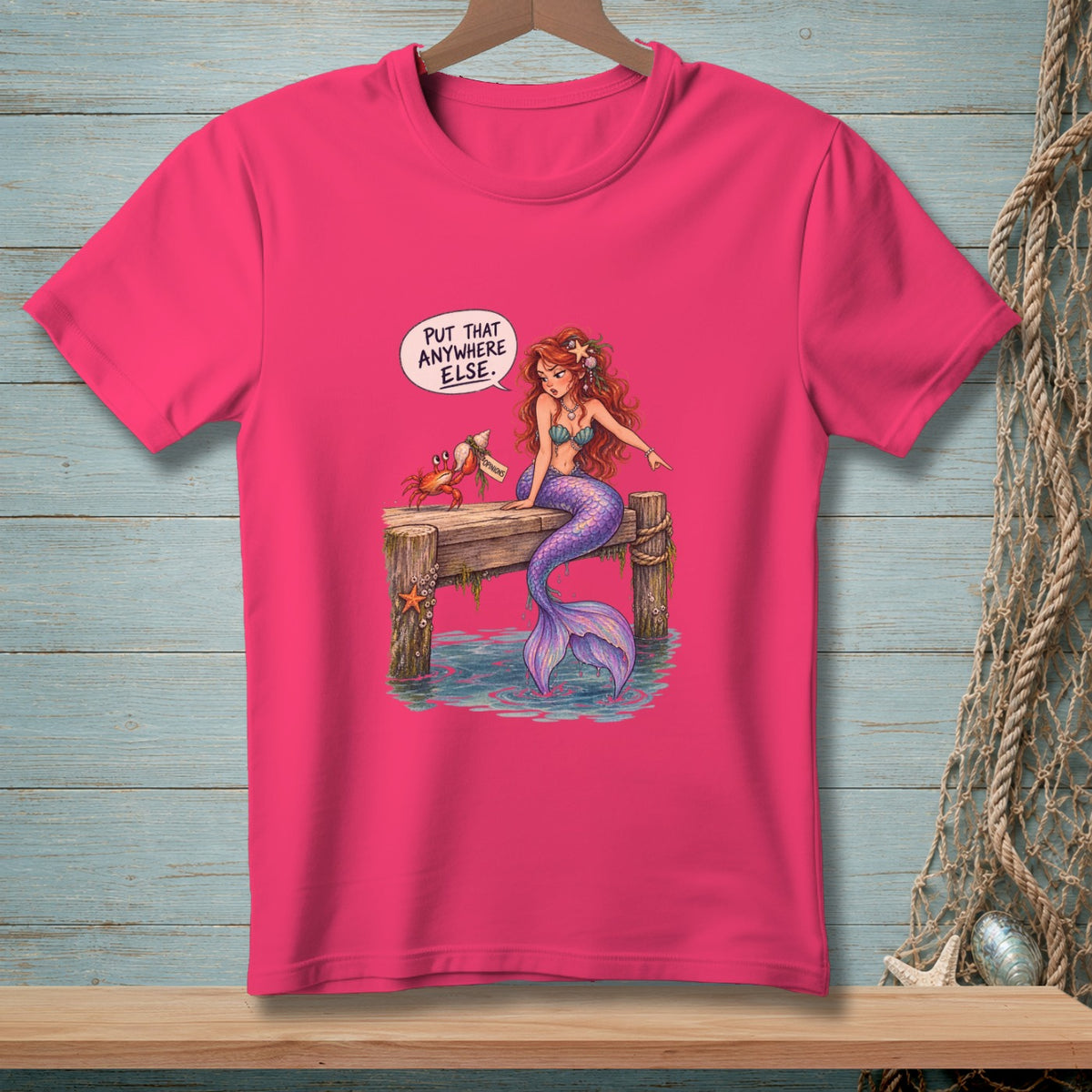 Mermaid and crab on pier with speech bubble reading "PUT THAT ANYWHERE ELSE."