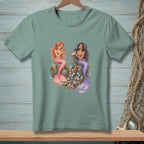 Two mermaids sit on rocks, one with pink tail, the other purple, surrounded by trash.