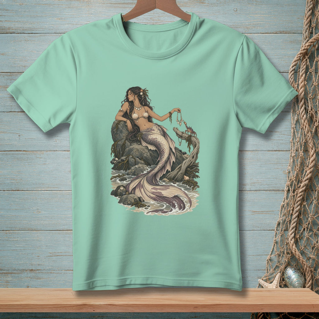 Mint green t-shirt with a mermaid sitting on rocks, holding a pearl necklace.