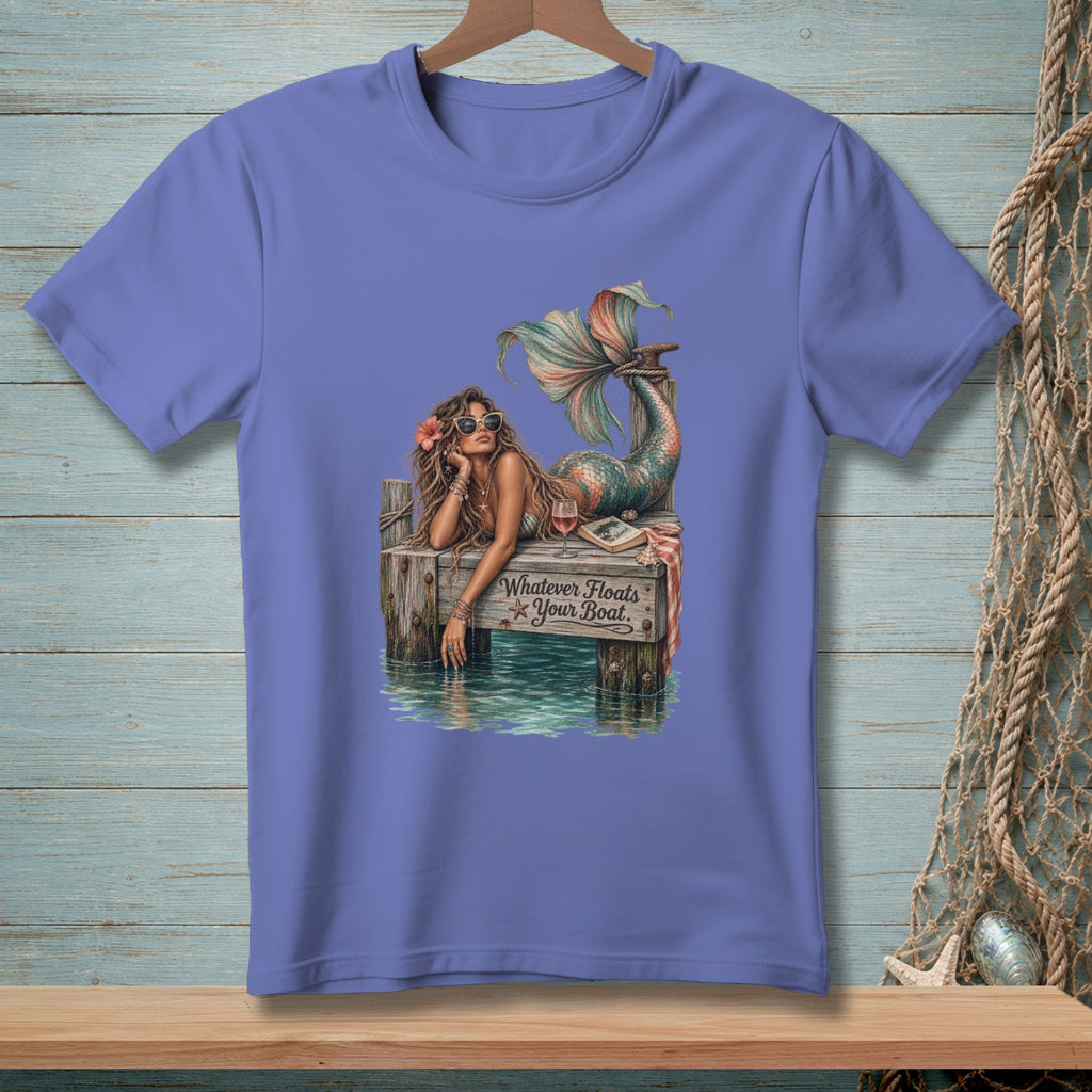 Mermaid lounging on a dock with text: Whatever Floats Your Boat.