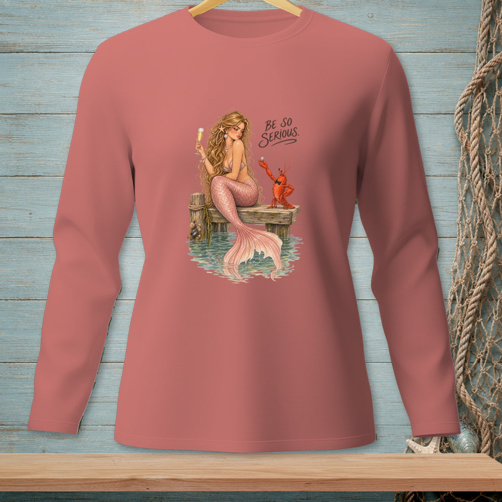 Mermaid and lobster with "BE SO SERIOUS" text on a pink long-sleeved shirt.