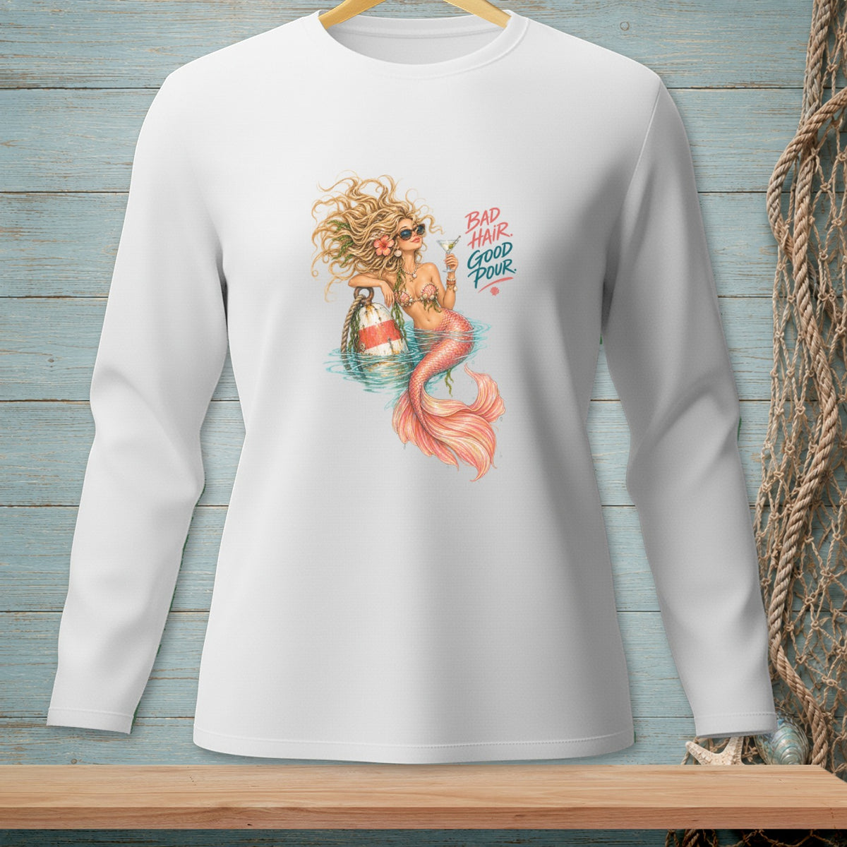 White long-sleeve shirt with mermaid holding a drink and text "BAD HAIR GOOD POUR."