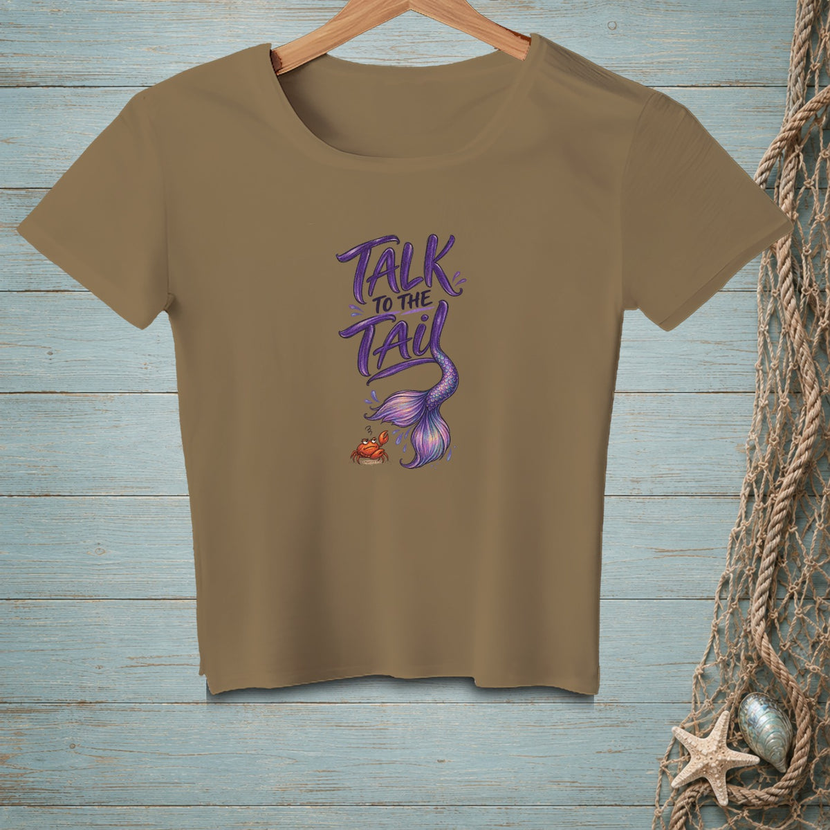 Brown t-shirt with "Talk to the Tail" text and mermaid tail graphic.