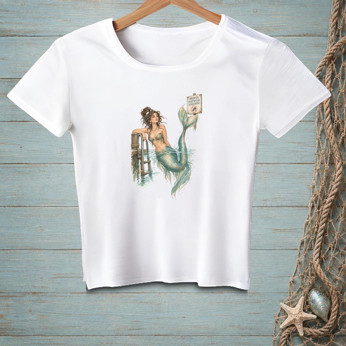 White t-shirt with a mermaid illustration and a "Proper Footwear Required" sign.