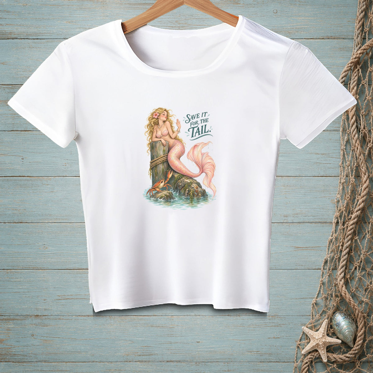 White t-shirt with a mermaid graphic and text "SAVE IT FOR THE TAIL".