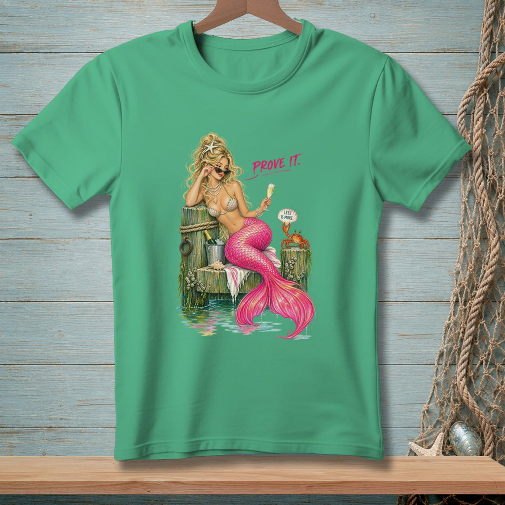 Mermaid on a dock with champagne, text "PROVE IT." and "LESS IS MORE."