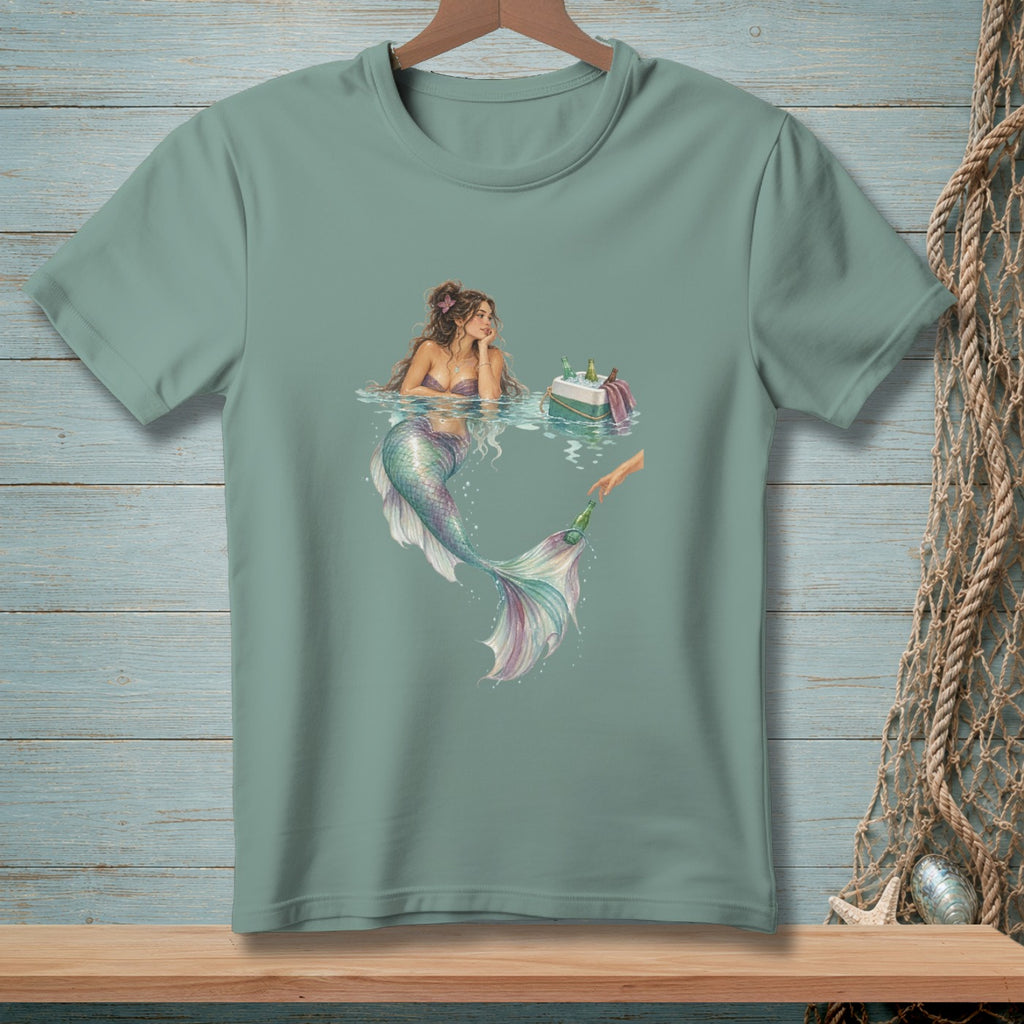 A mermaid rests in water next to a cooler of drinks, reaching for a bottle.