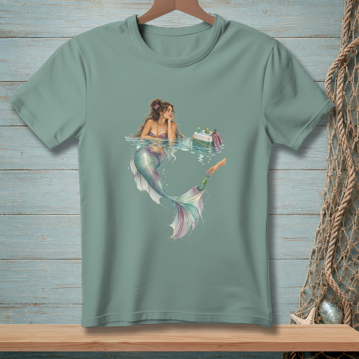 A mermaid rests in water next to a cooler of drinks, reaching for a bottle.