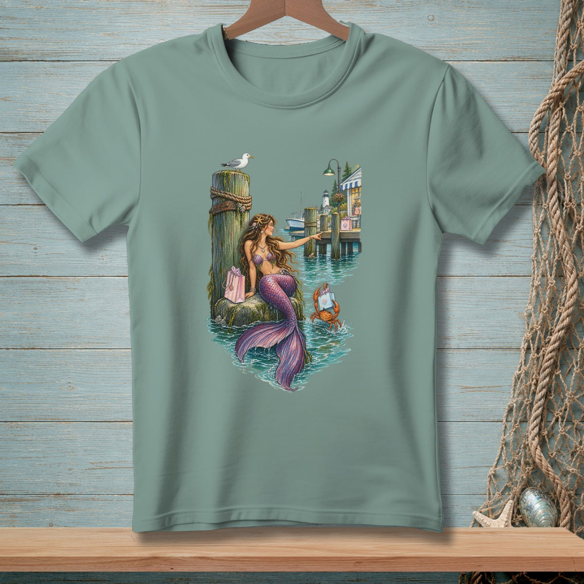 Mermaid sitting on a dock with a crab, shops, and lighthouse in background.