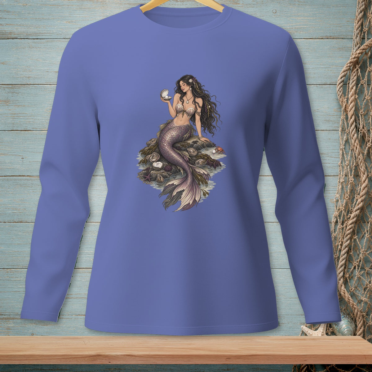 Periwinkle long-sleeve shirt with a mermaid holding a pearl from an oyster.
