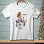 Mermaid with wine and crab on pier, with text "Handled."