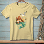Light yellow t-shirt with a mermaid and seagull graphic.