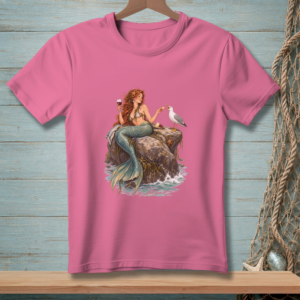Pink t-shirt with mermaid sitting on a rock with a seagull and wine.