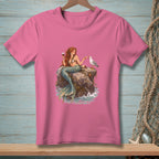 Pink t-shirt with mermaid sitting on a rock with a seagull and wine.