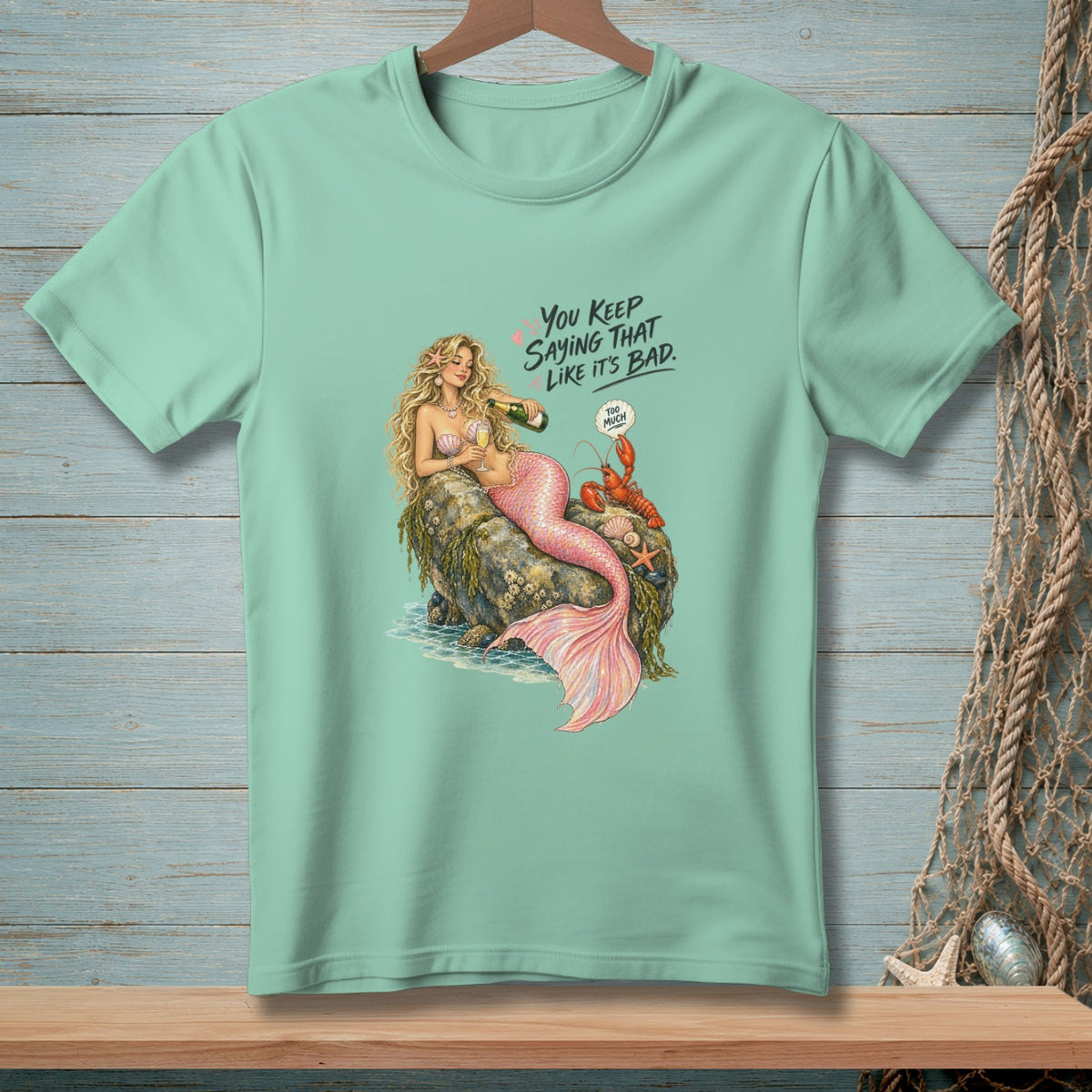 Mermaid and lobster on rock with champagne. Text reads, "You keep saying that like it's bad."