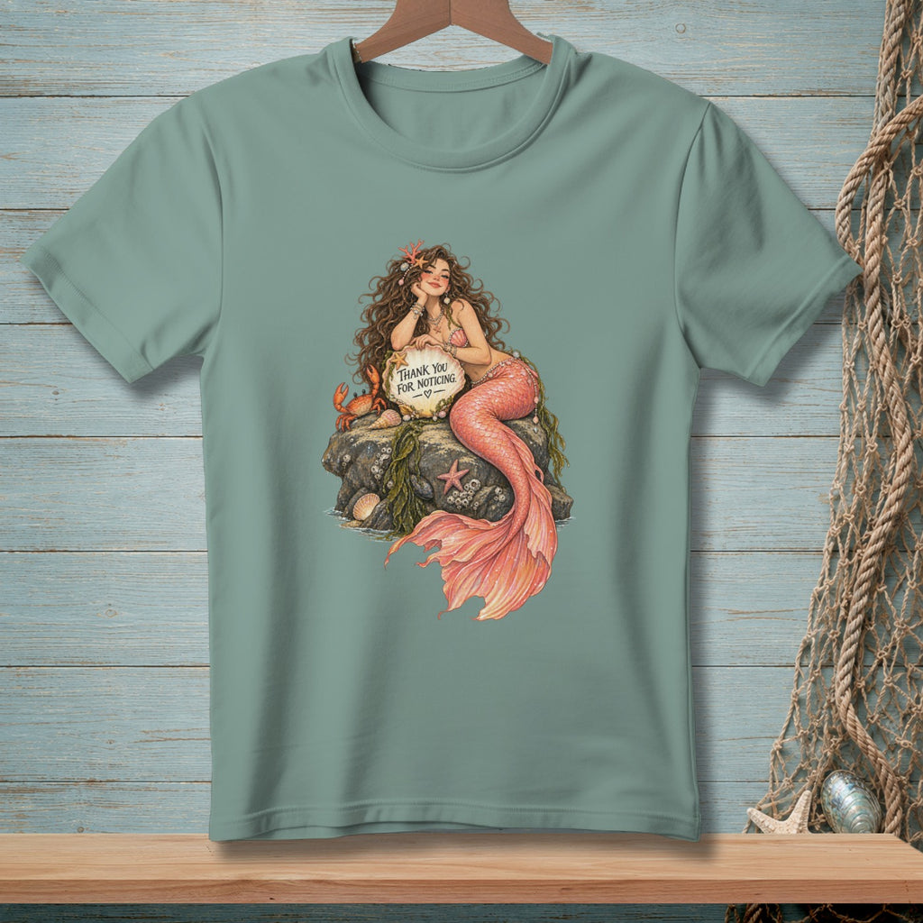 Mermaid with pink tail on rock holds sign saying "Thank You For Noticing."