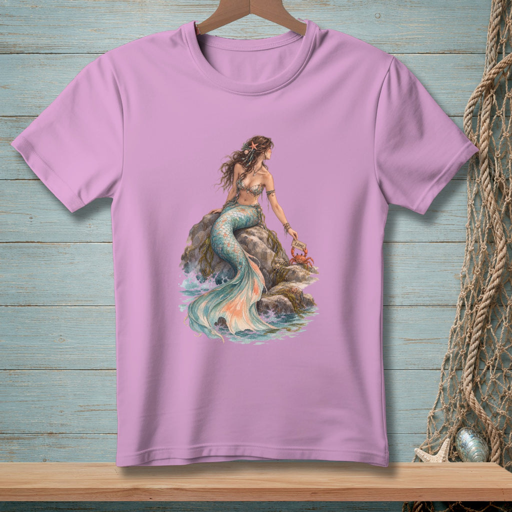 Lavender t-shirt with watercolor graphic of a mermaid sitting on rocks holding a crab and a sign.