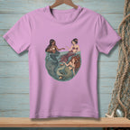 Three mermaids with tails in shades of gray, burgundy, and green interact in water.