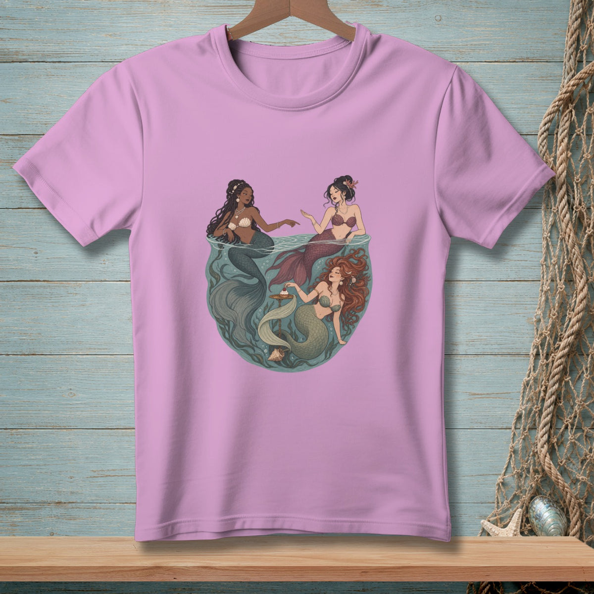 Three mermaids with tails in shades of gray, burgundy, and green interact in water.