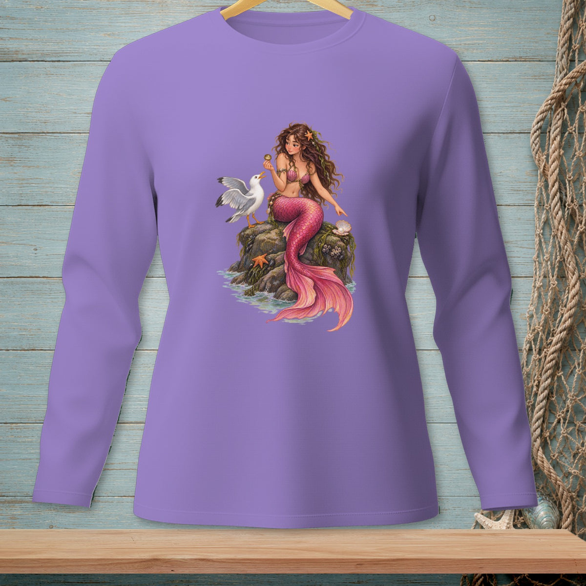 Mermaid sitting on a rock with a seagull and seashells.