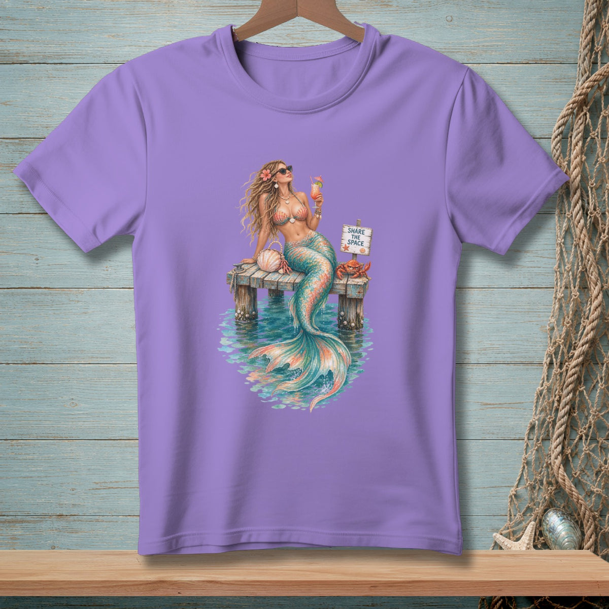 Purple t-shirt with a mermaid holding a drink on a dock, with text "SHARE THE SPACE".