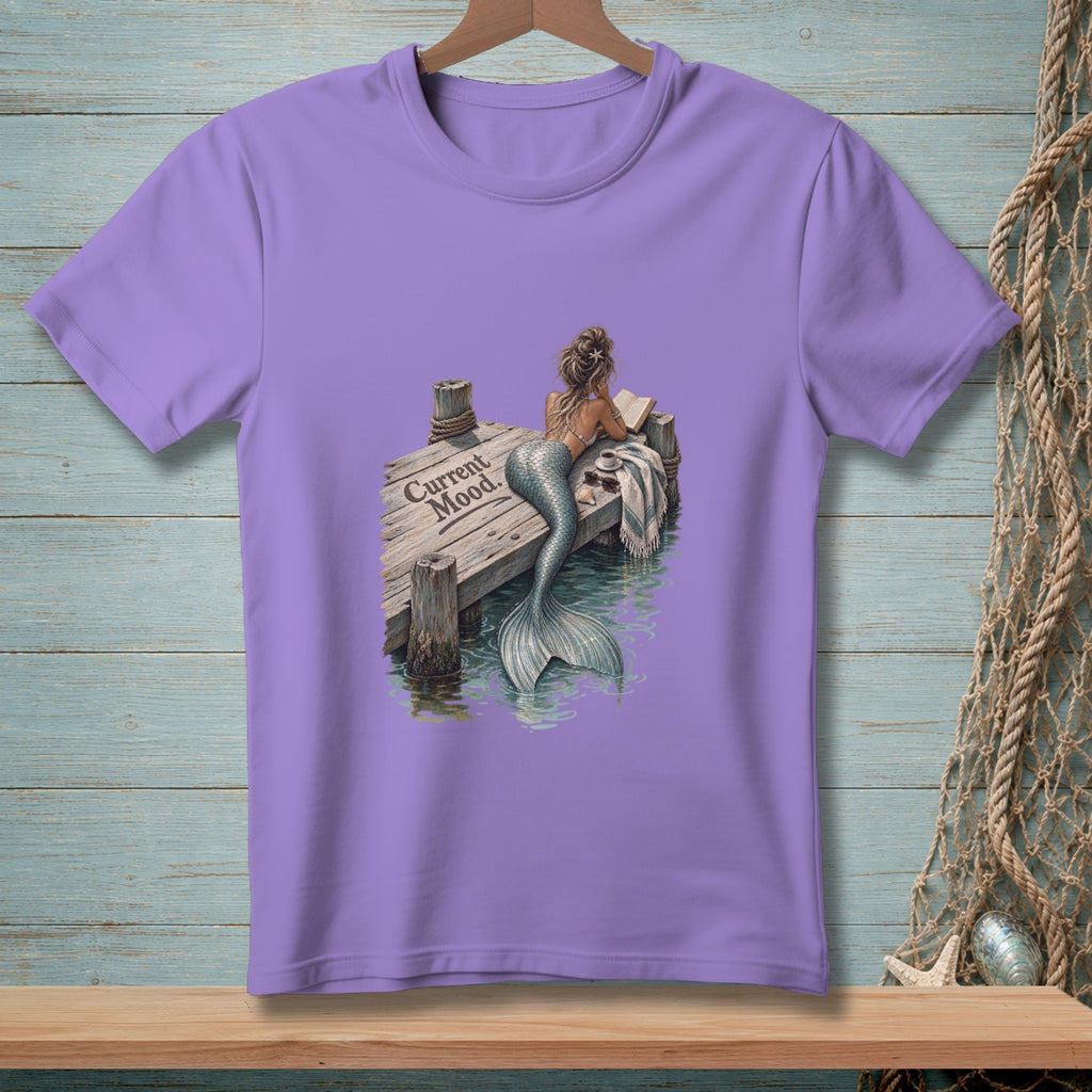 Lavender t-shirt with mermaid reading on dock, text "Current Mood".