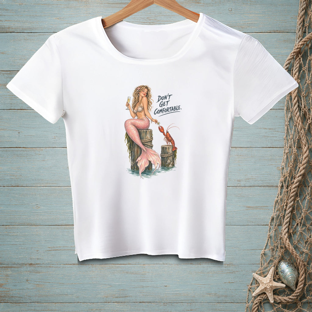 White t-shirt with mermaid, lobster, and text "DON'T GET COMFORTABLE."