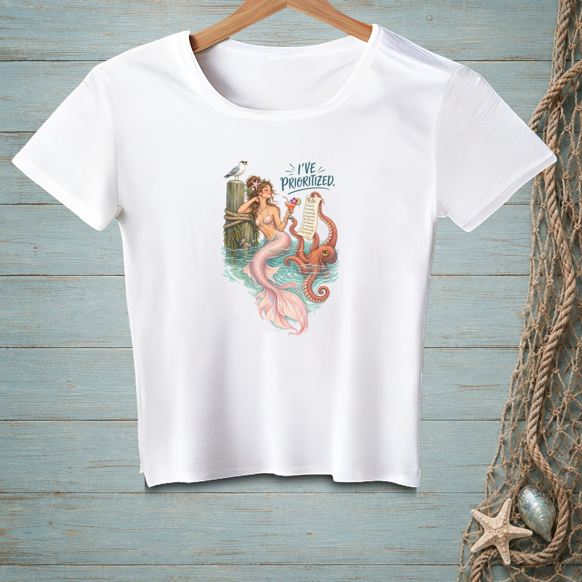 White t-shirt with mermaid, octopus, and text "I've Prioritized."