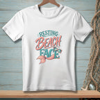 White t-shirt with "Resting Beach Face" text, sunglasses, and mermaid tail graphic.