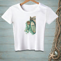 White t-shirt with graphic of mermaid reading by a paddleboard at a dock.