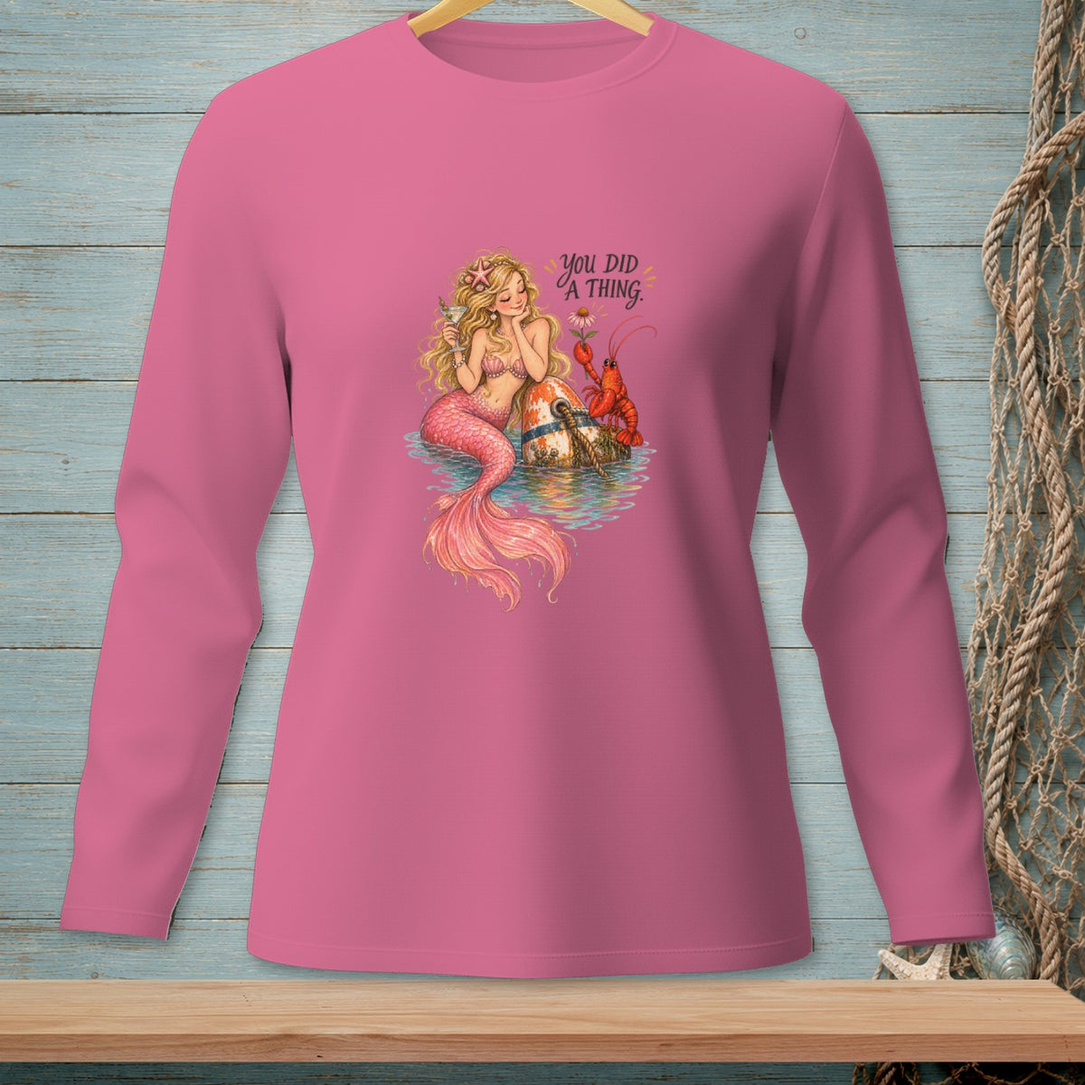 Pink long-sleeved shirt with mermaid, lobster, and text "YOU DID A THING."